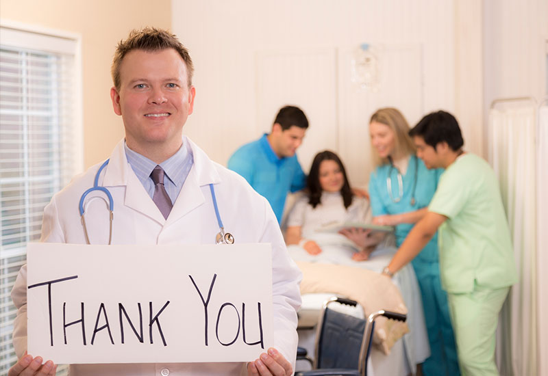 Doctor holding "Thank You" sign